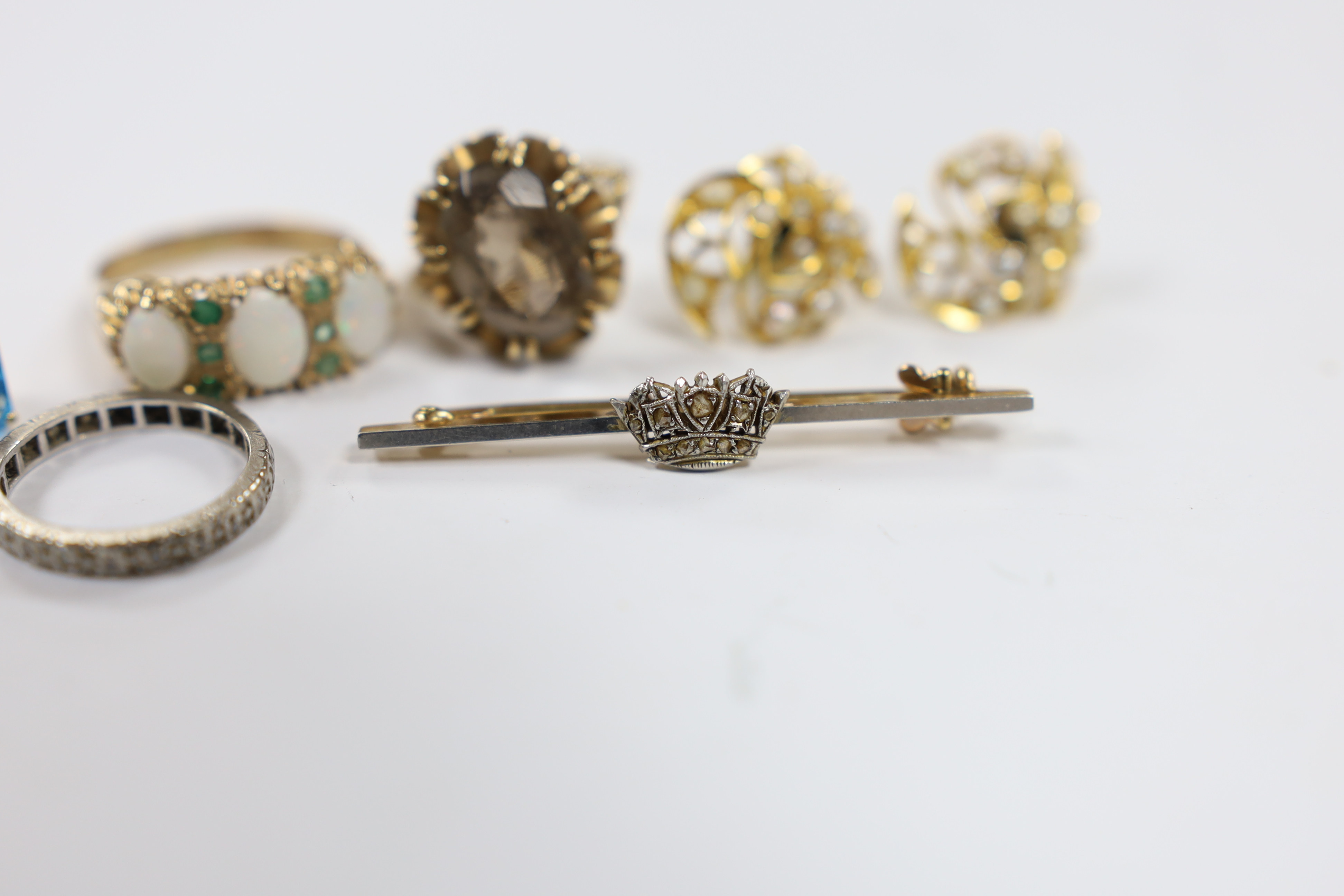 Assorted jewellery including a modern pair of 14k and blue topaz earrings, a pair of 375 and seed pearl cluster earrings, two 9ct gold and gem set rings including a white opal and emerald chip, a white metal and diamond